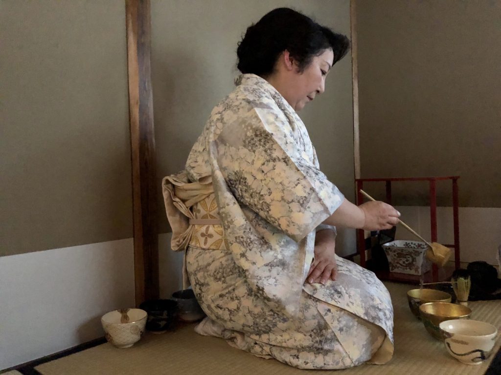 Japan tea ceremony lady serving a traditional matcha tea during the tea ceremony